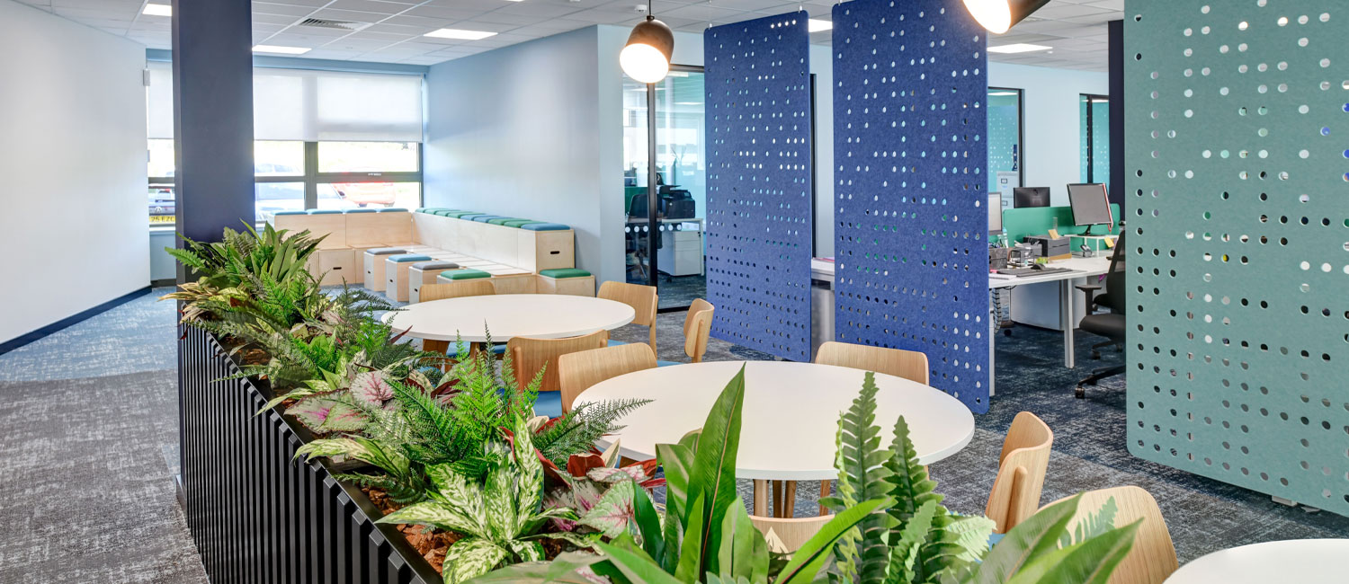Office zoning and partitioning with hanging acoustic panels and freestanding office planters